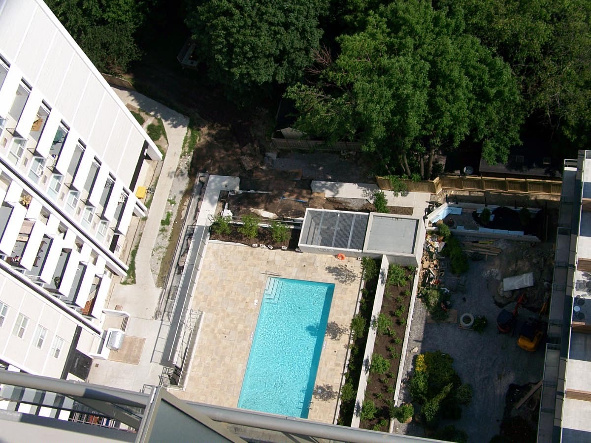 Aerial view of modern building and pool.
