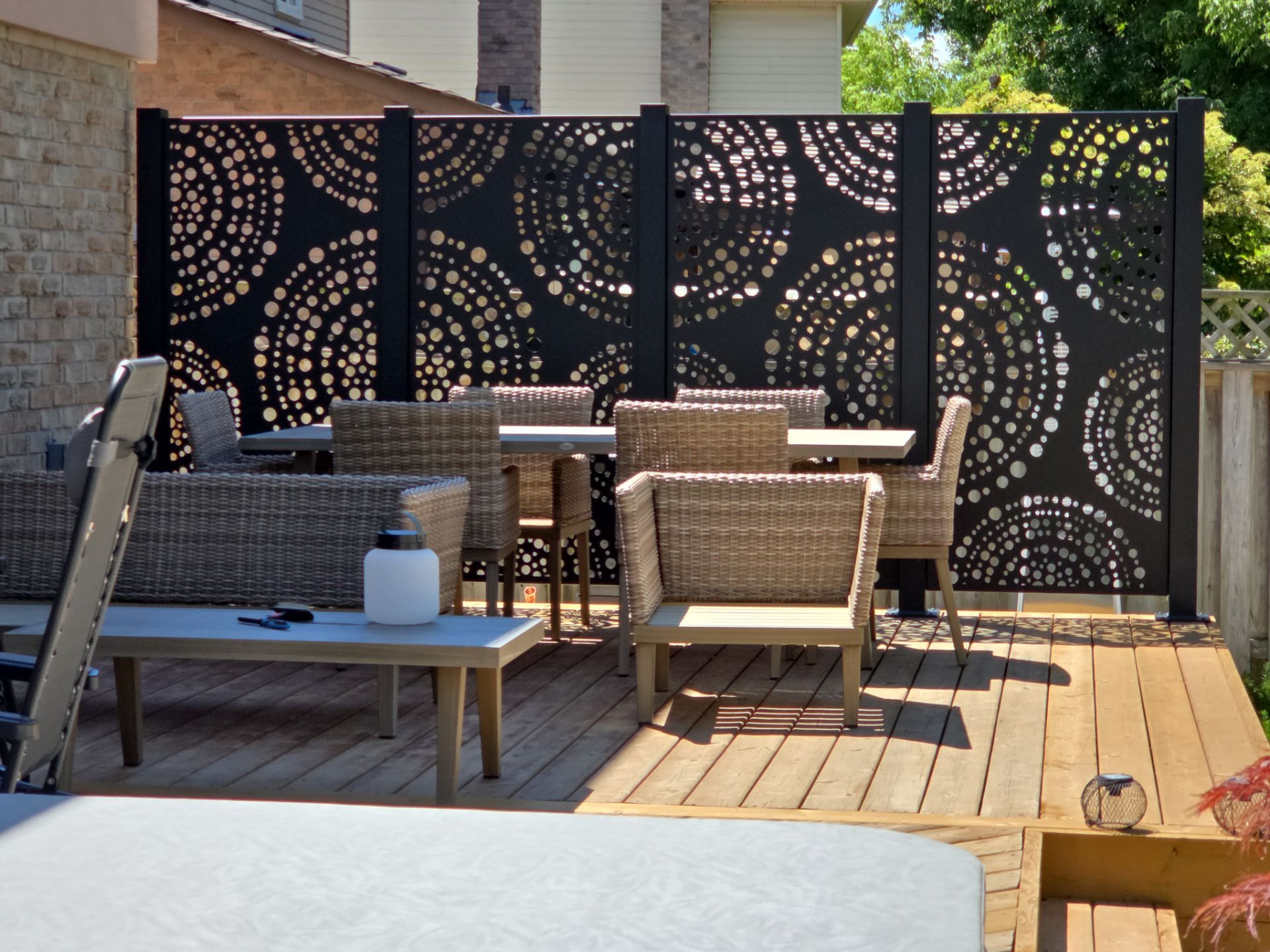 Patio with decorative privacy screen and seating area.