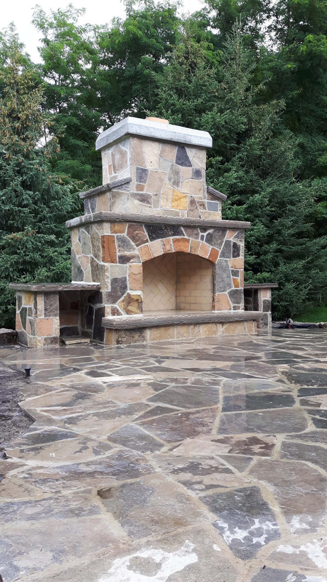 Stone outdoor fireplace on a patio