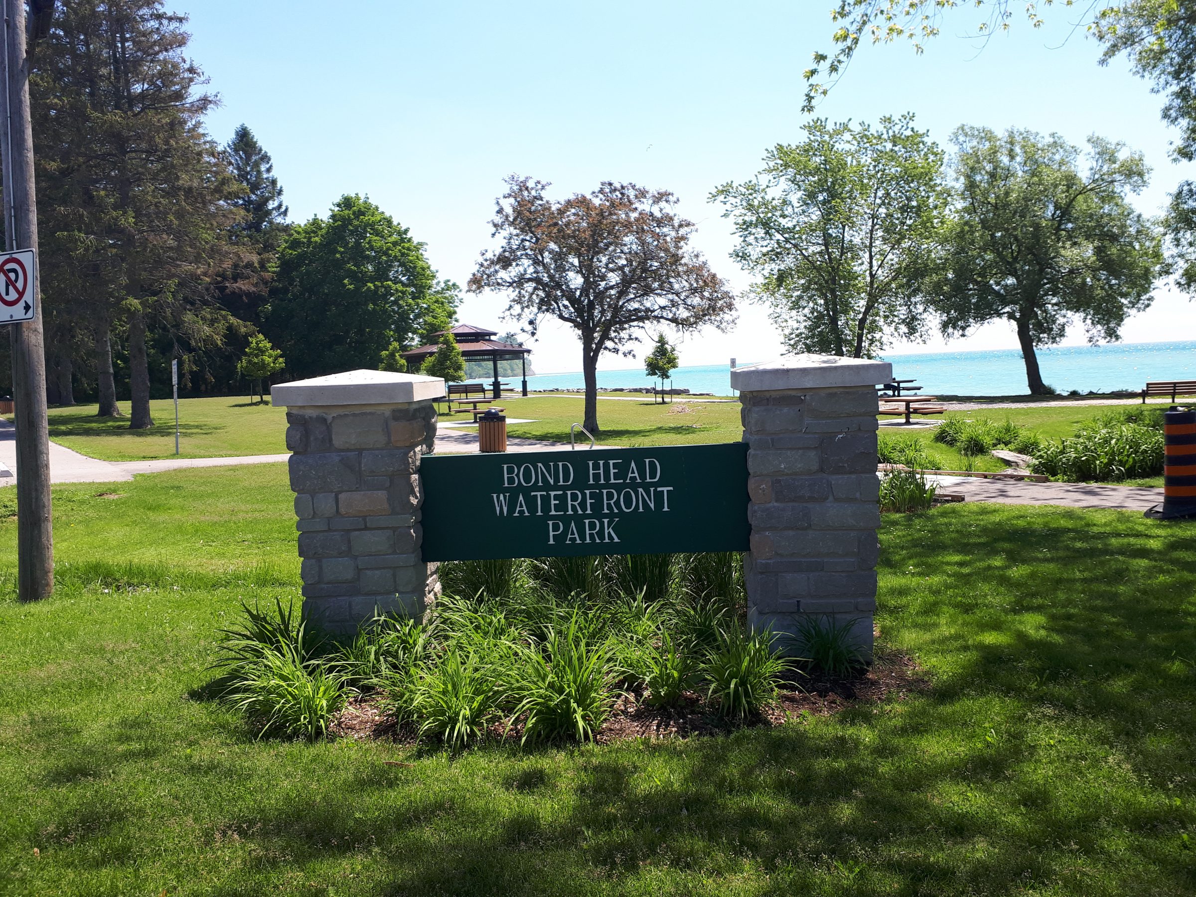 Bond Head Waterfront Park entrance with trees and lake.