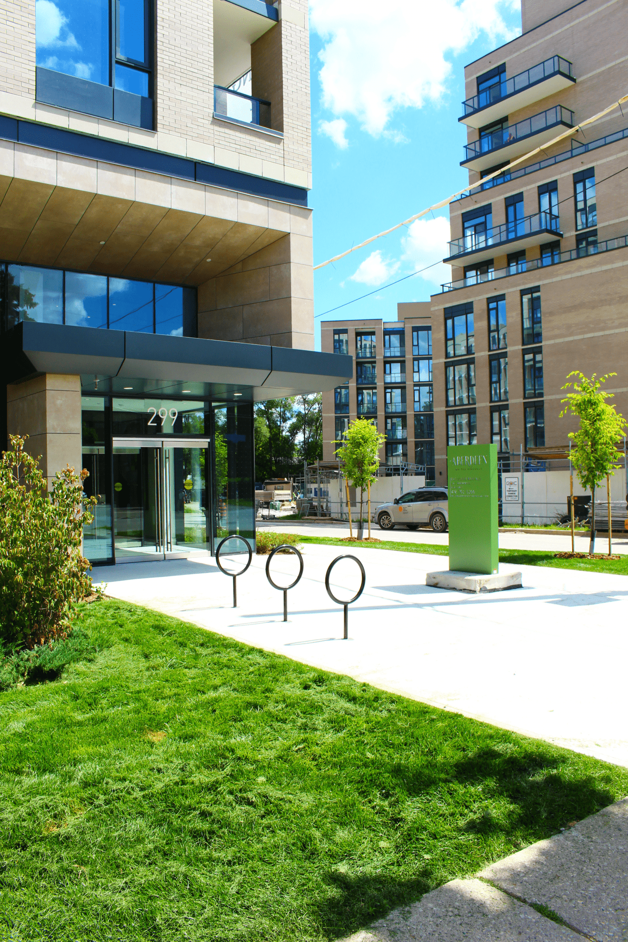 Modern apartment building entrance with green lawn