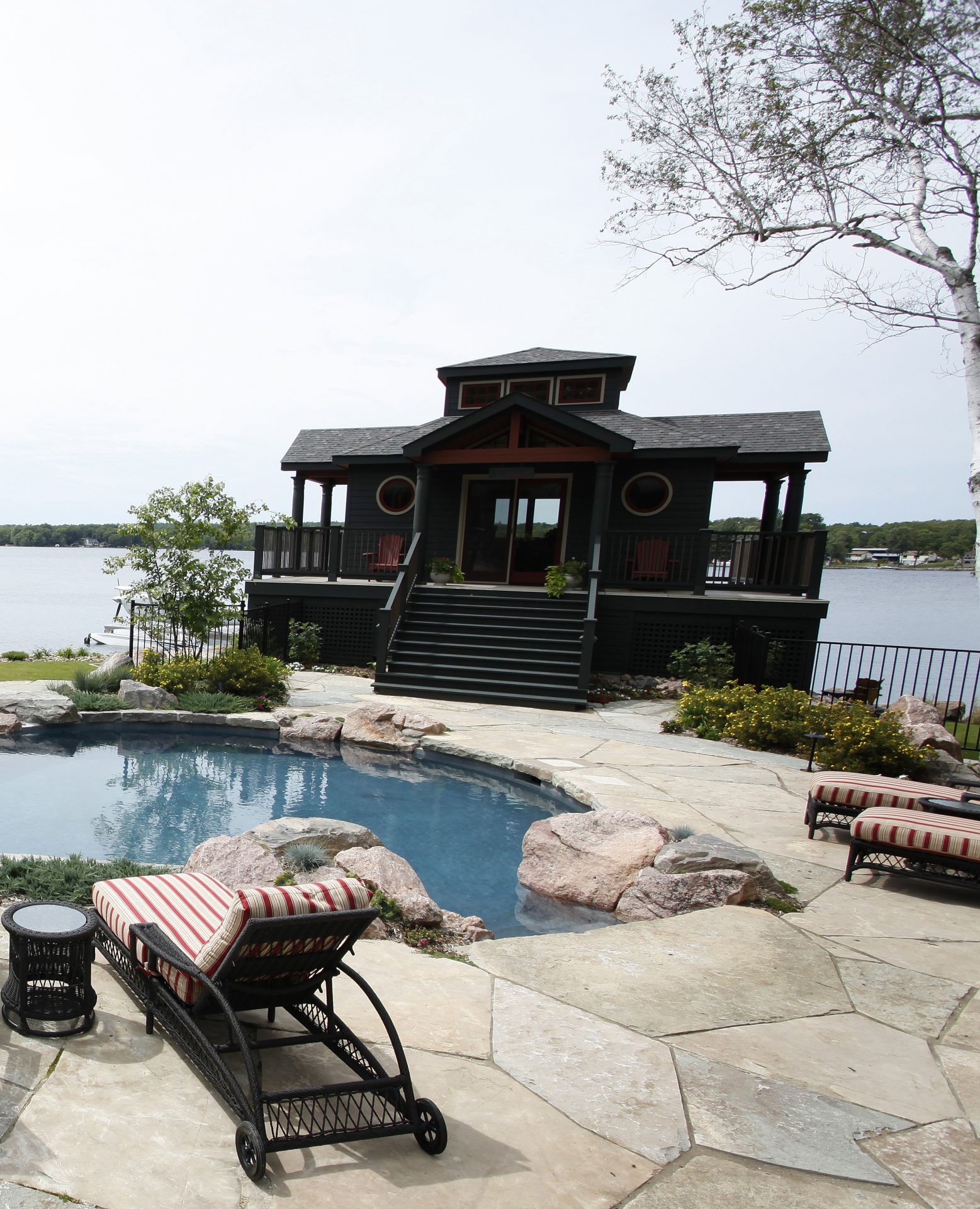 Lakefront house with pool and patio view.
