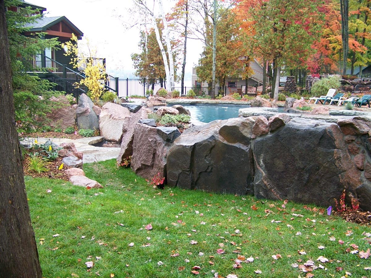 Rocky landscape with pool and autumn trees