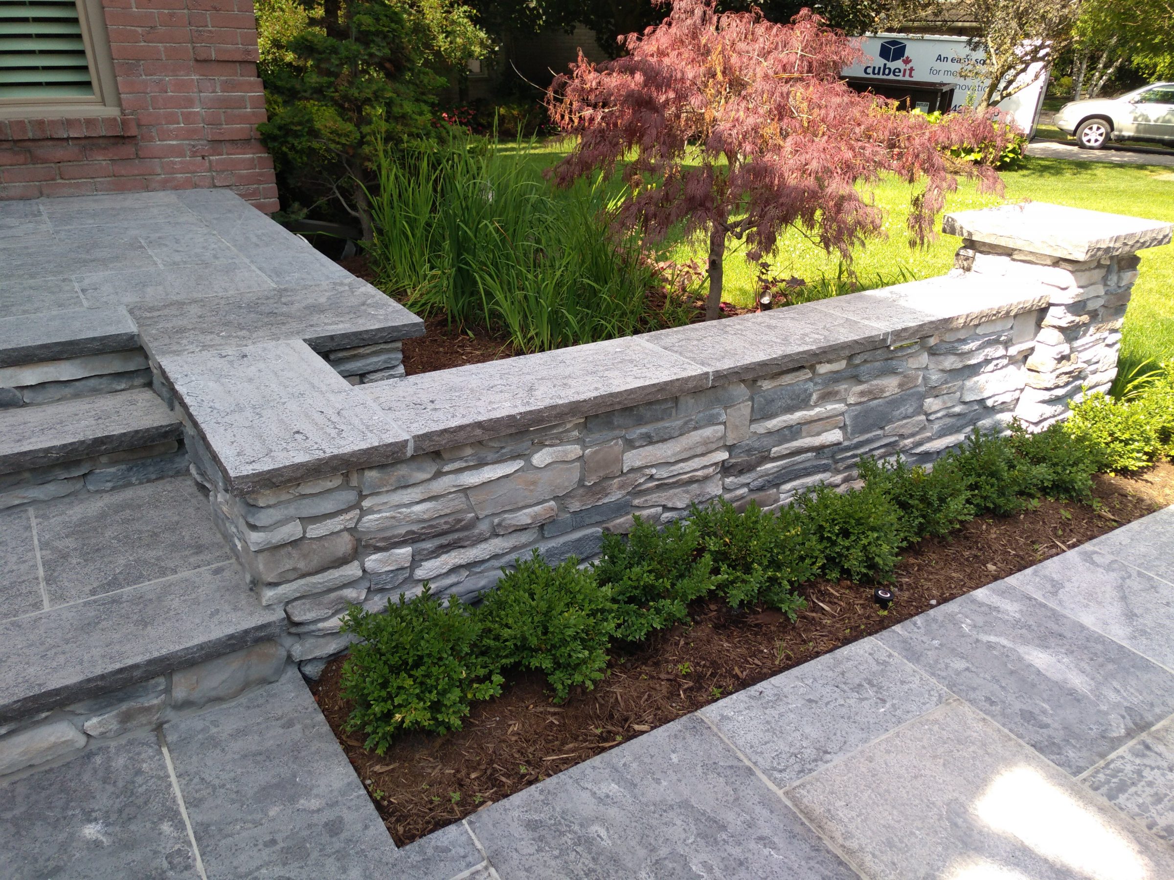 Gray stone patio with garden border