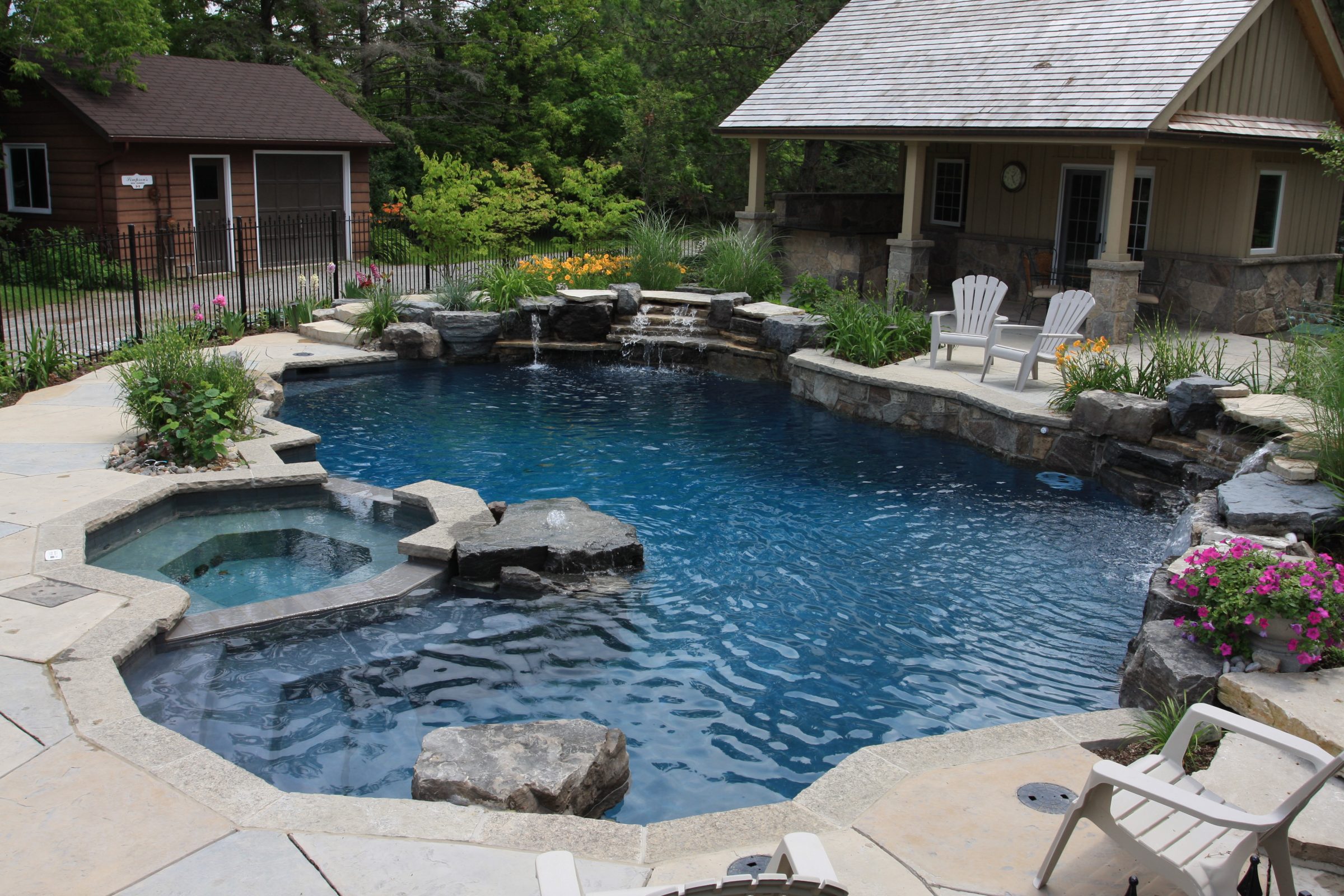 Outdoor pool with chairs and plants