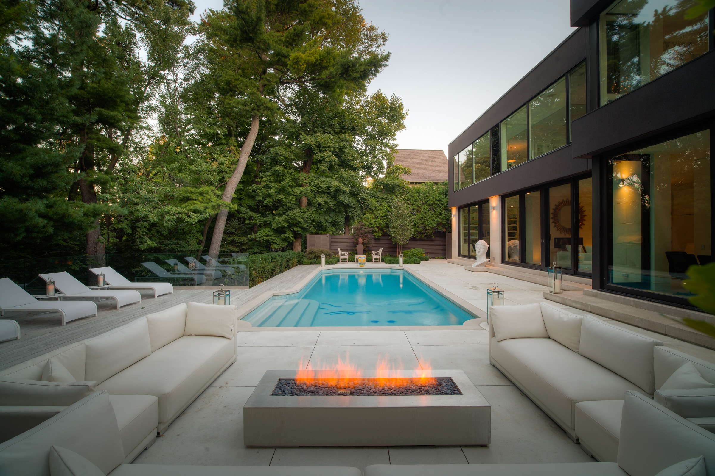 Modern patio with pool and fire pit.
