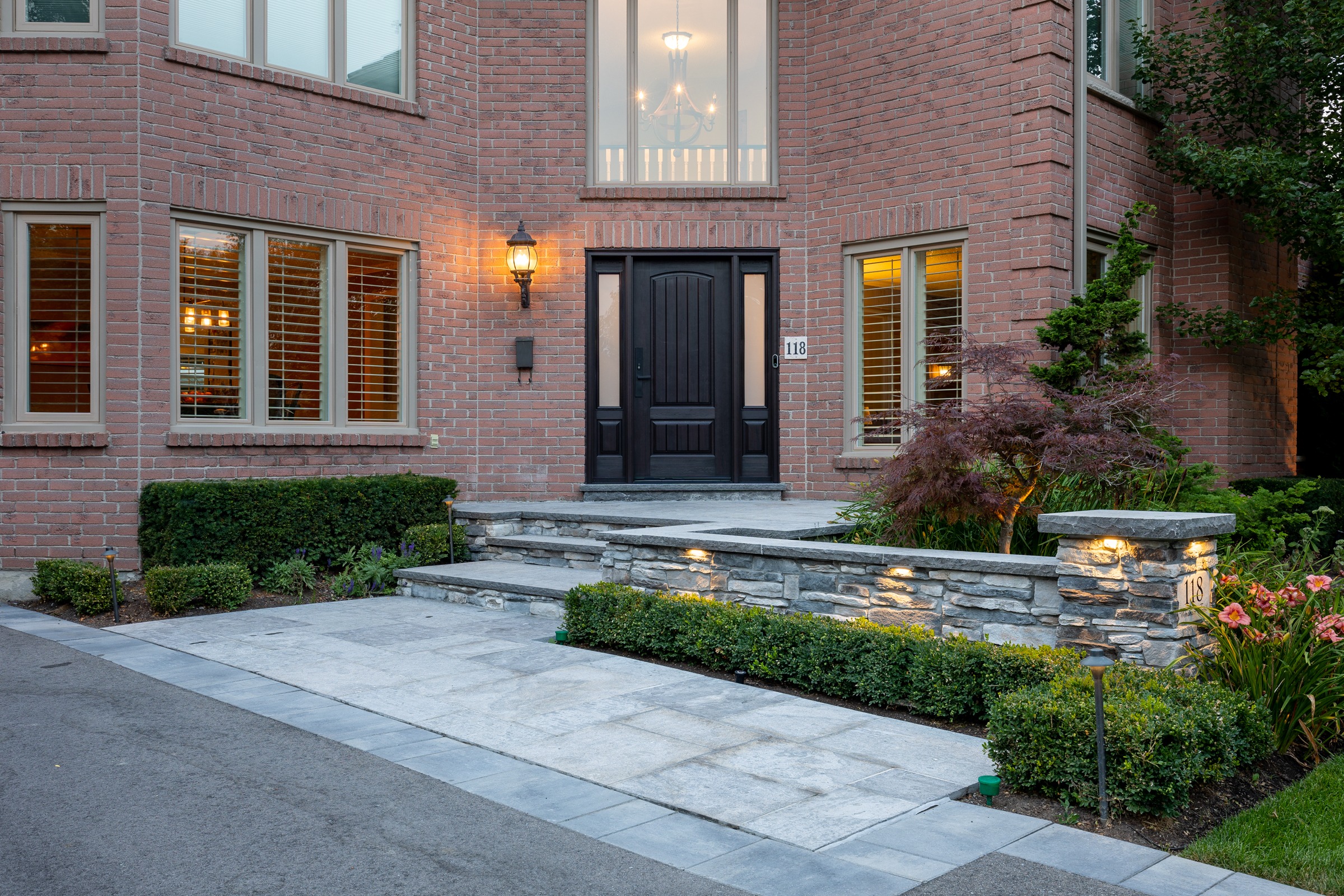 Elegant brick house entrance with landscaped garden