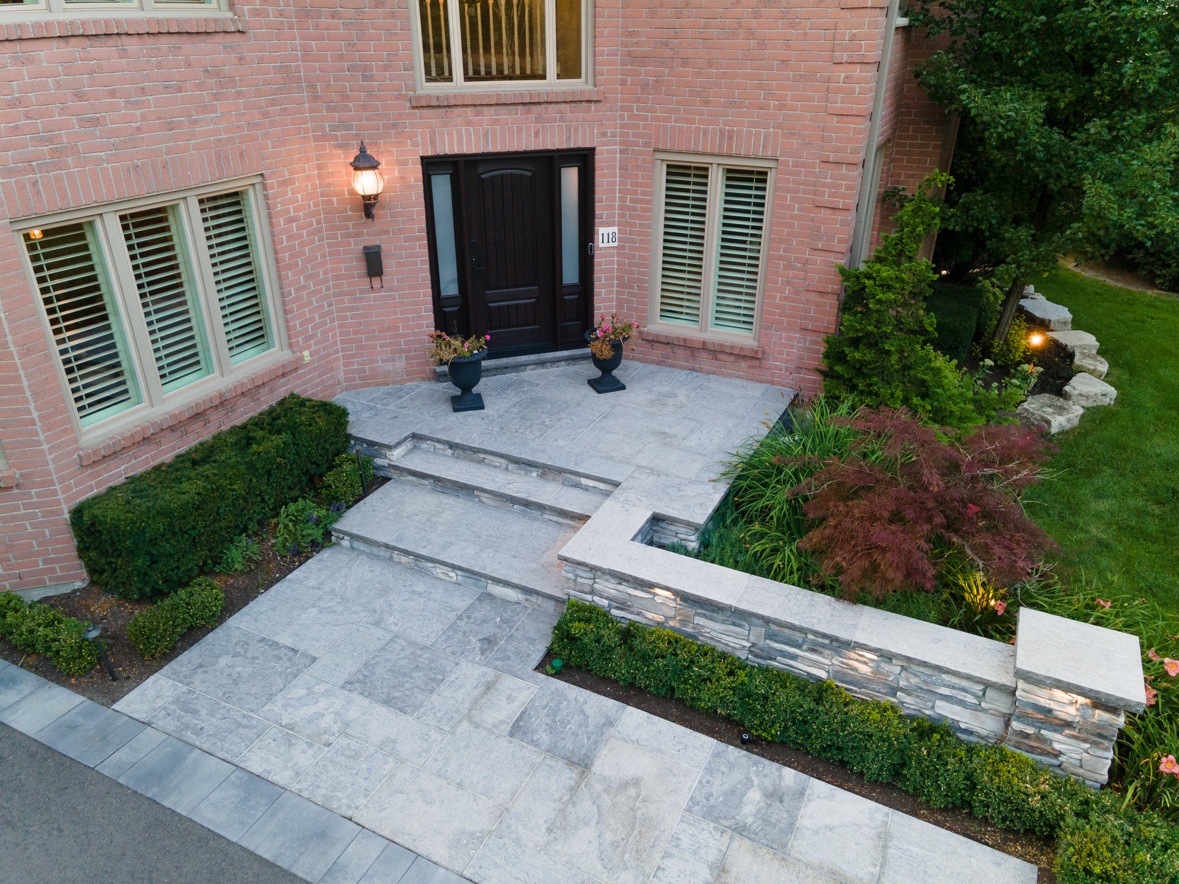 Brick house with landscaped front yard and steps.