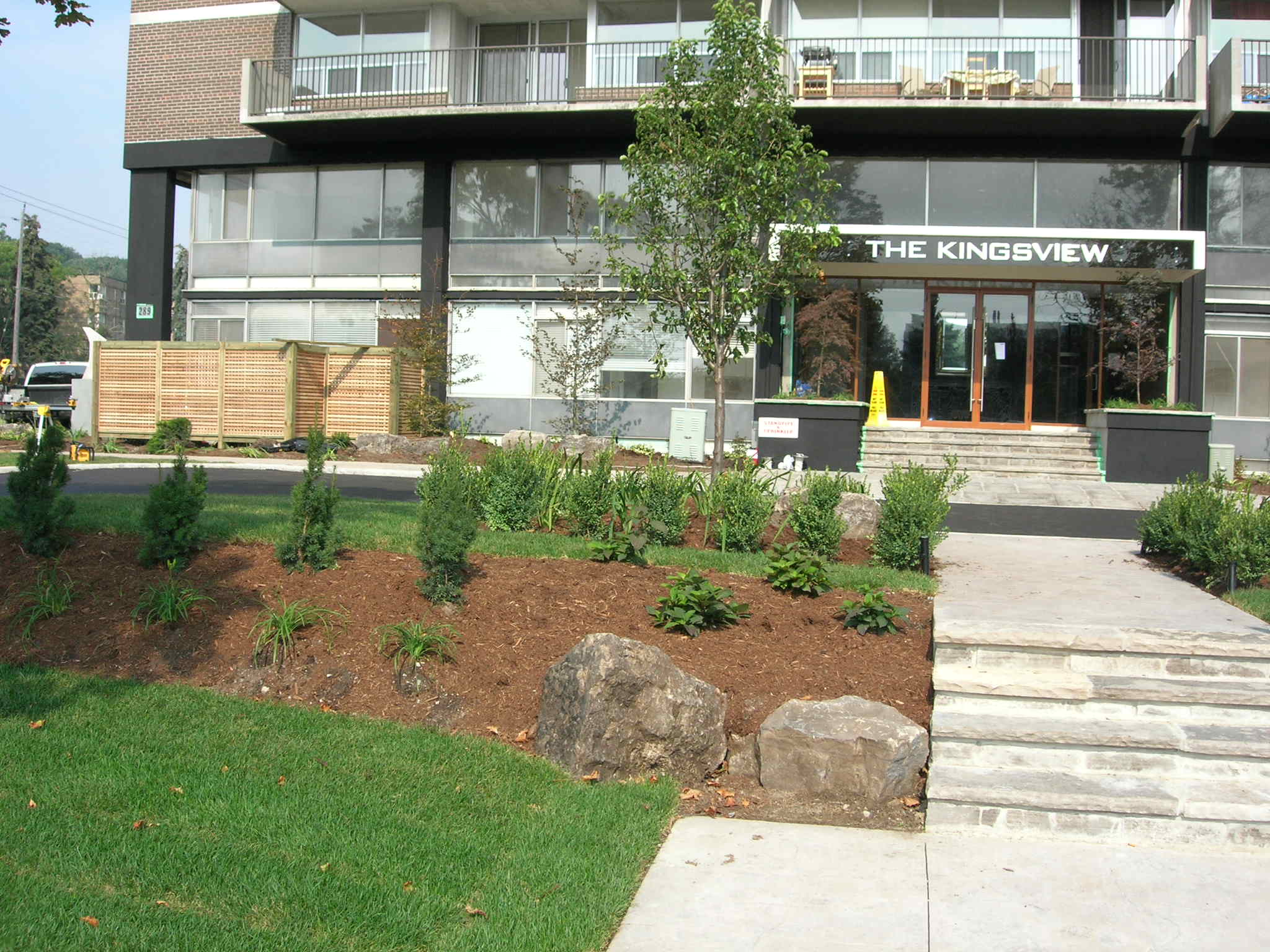Modern apartment entrance with landscaped garden
