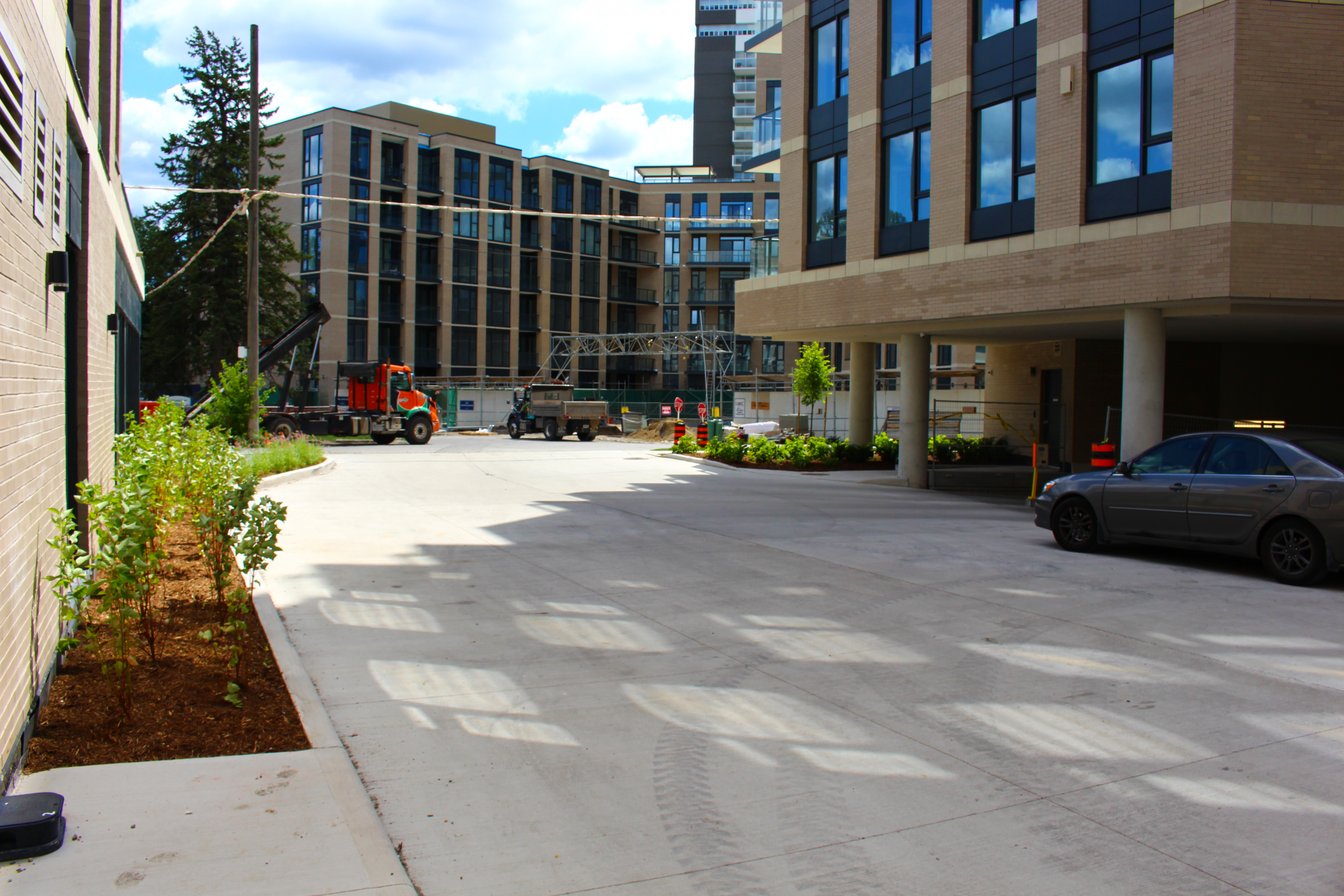 Urban construction site with vehicles and buildings.