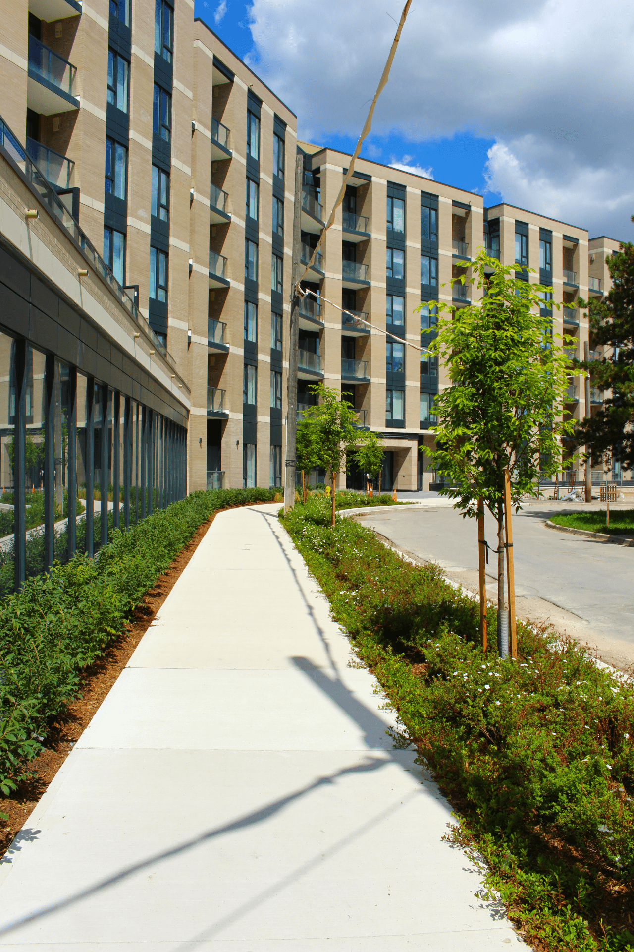 Modern apartment building with landscaped walkway.
