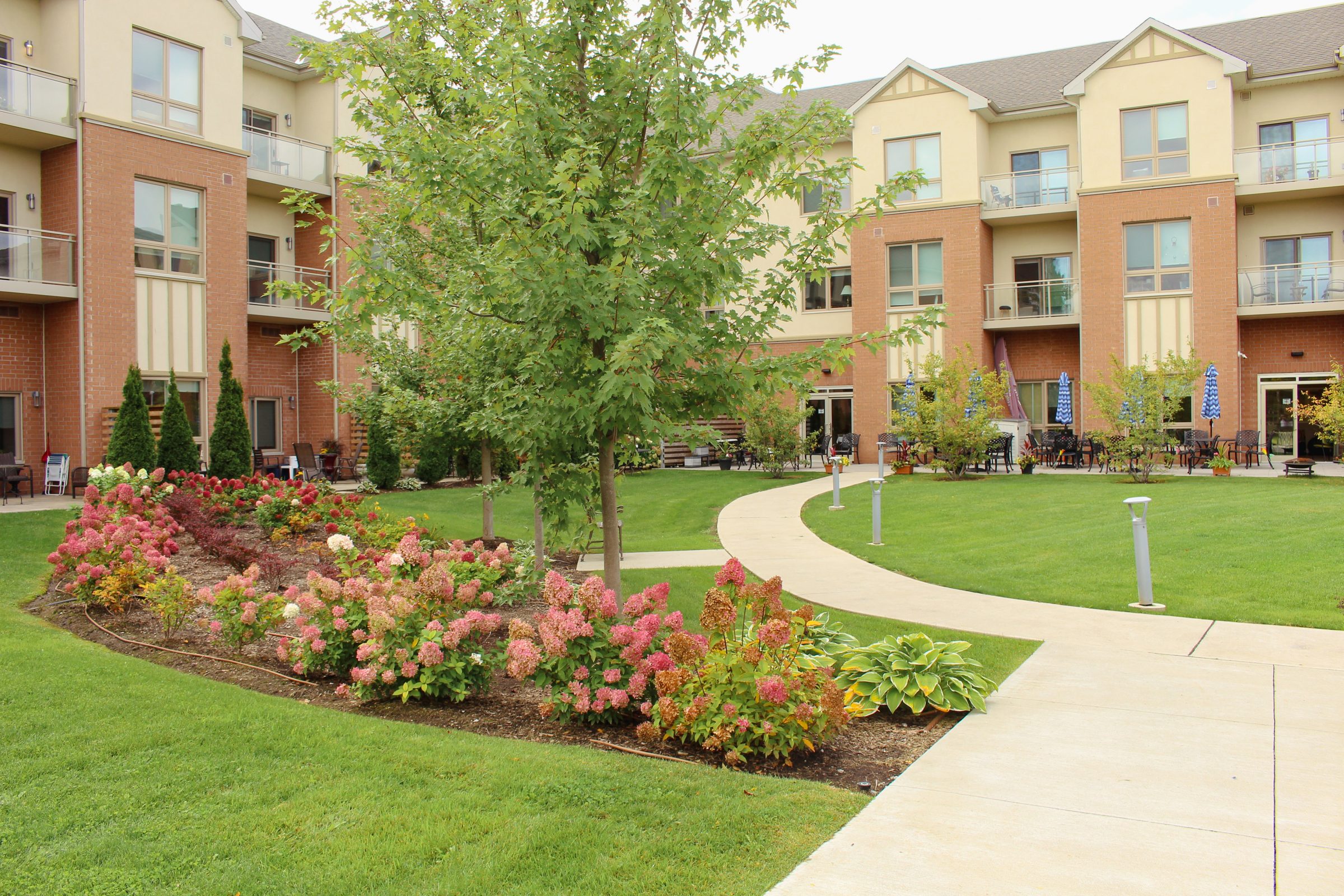 Beautiful courtyard with gardens and patio of building.