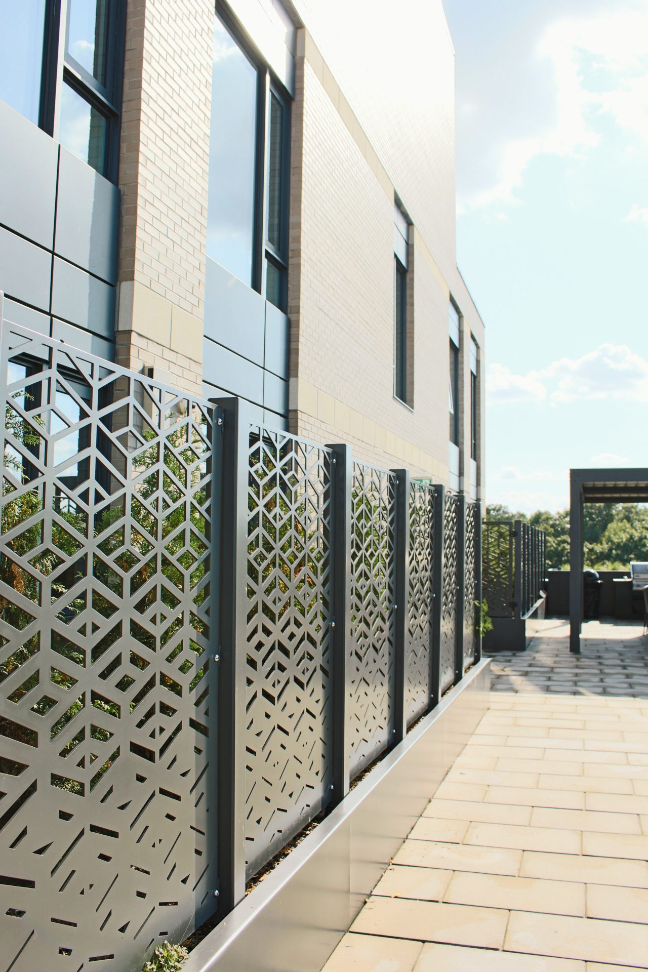 Modern building with geometric metal fence design.