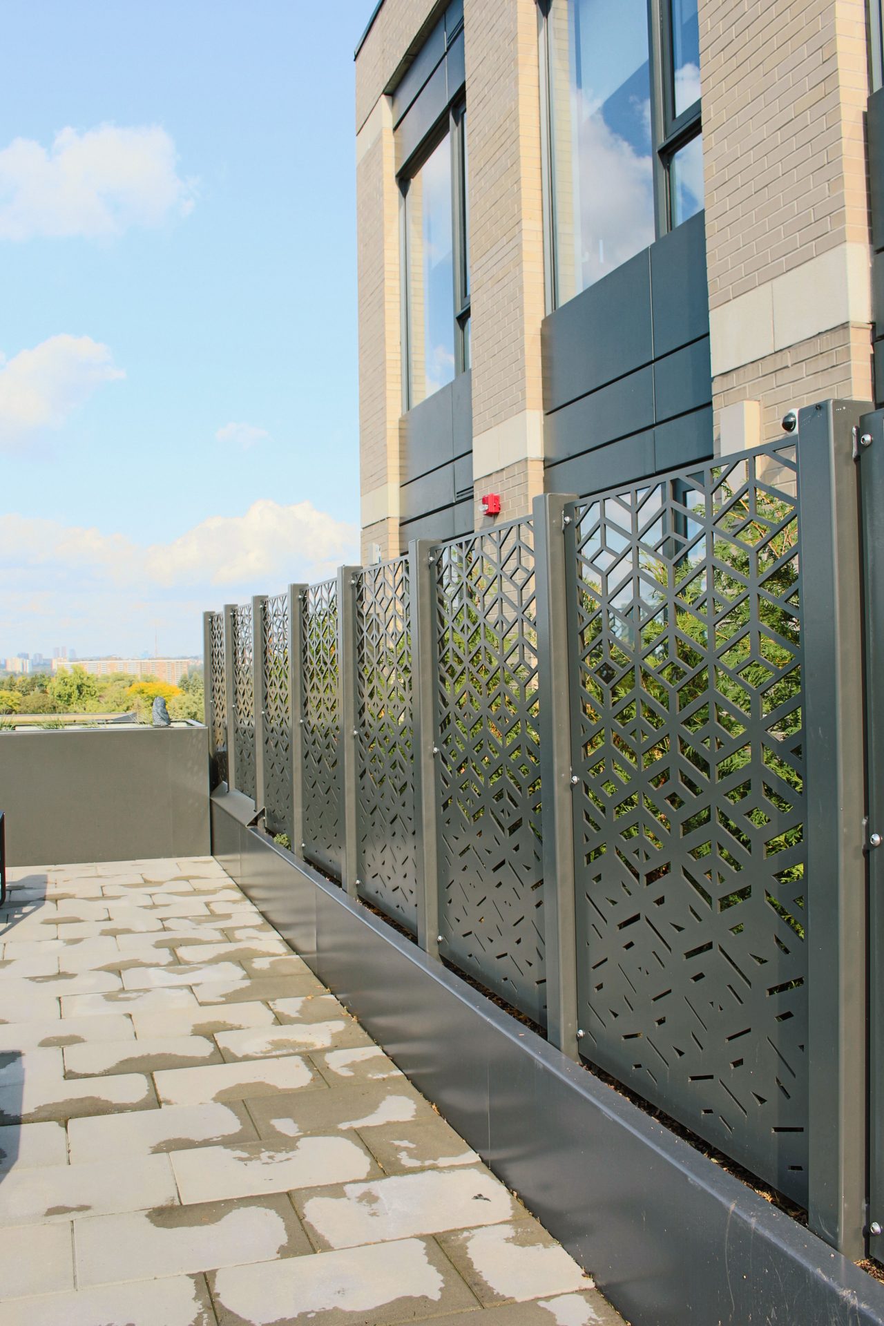 Modern brick building with decorative metal screens.