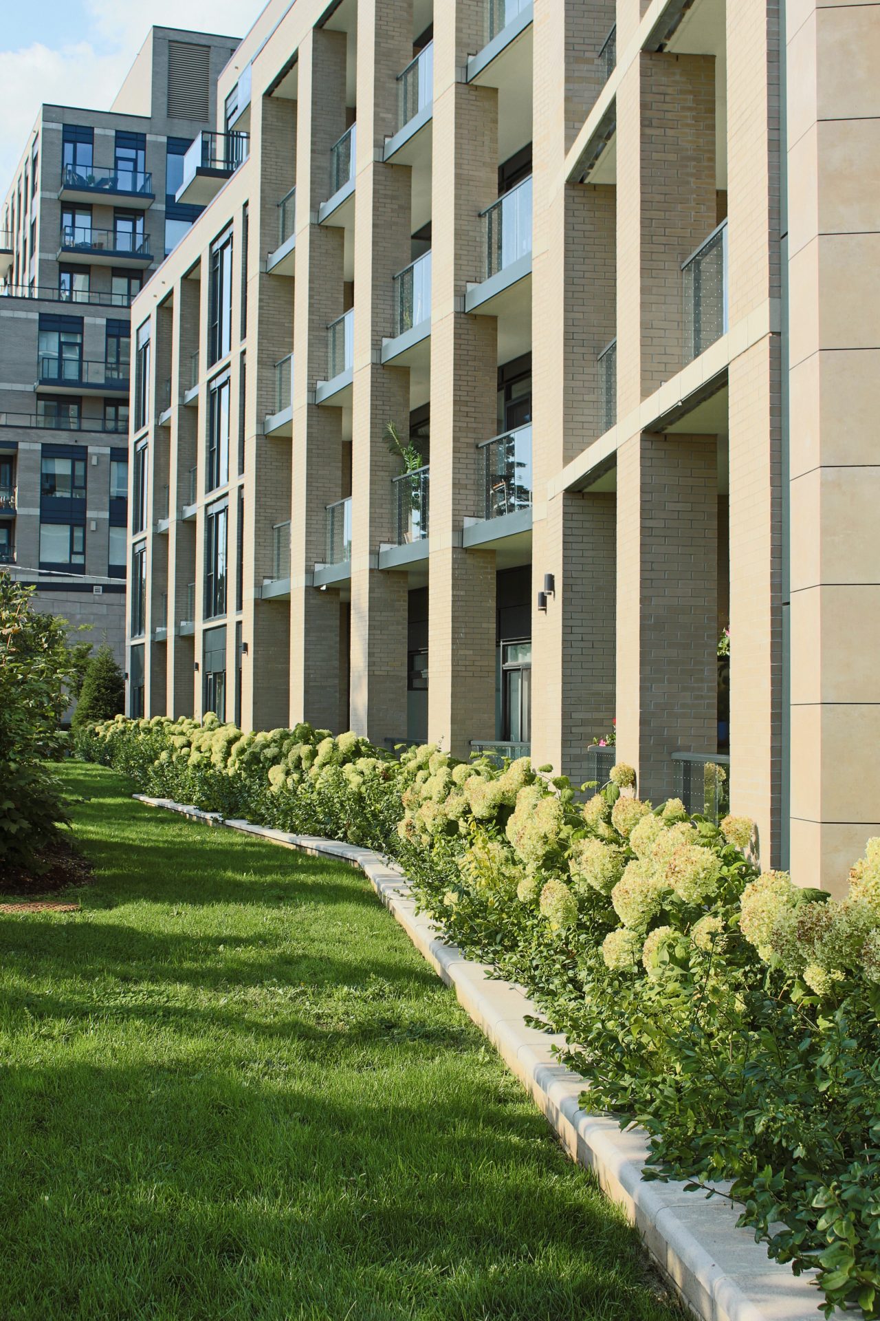 Modern apartment building with garden landscaping.