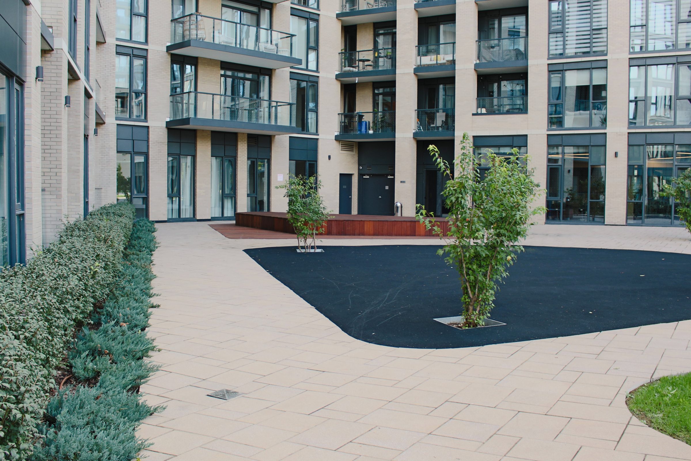 Modern apartment building with landscaped courtyard.