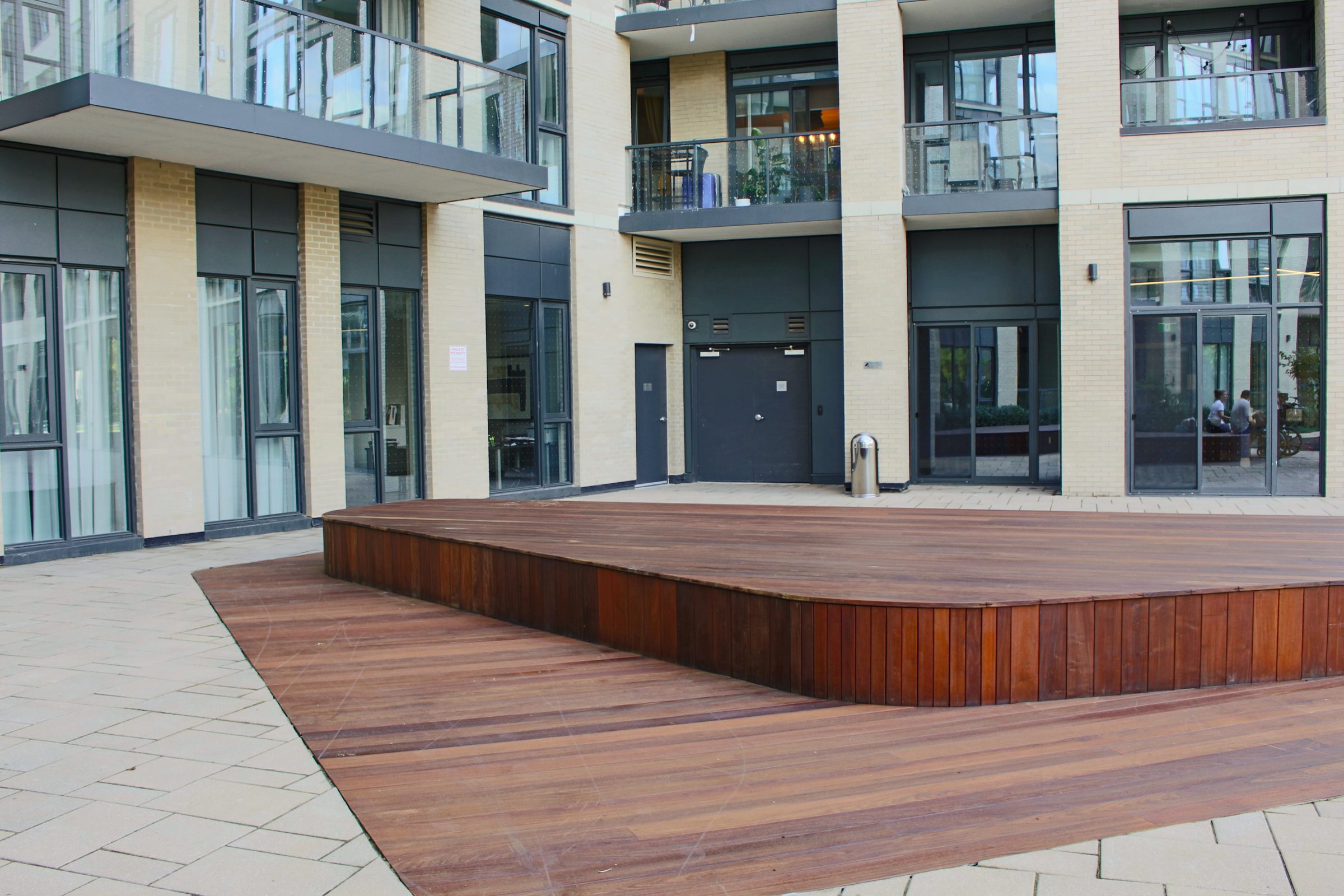 Courtyard with wooden stage and modern building