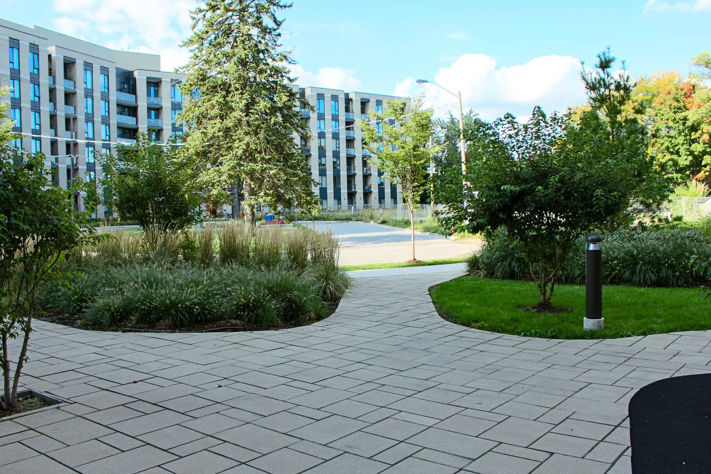 Modern apartment building with landscaped pathway