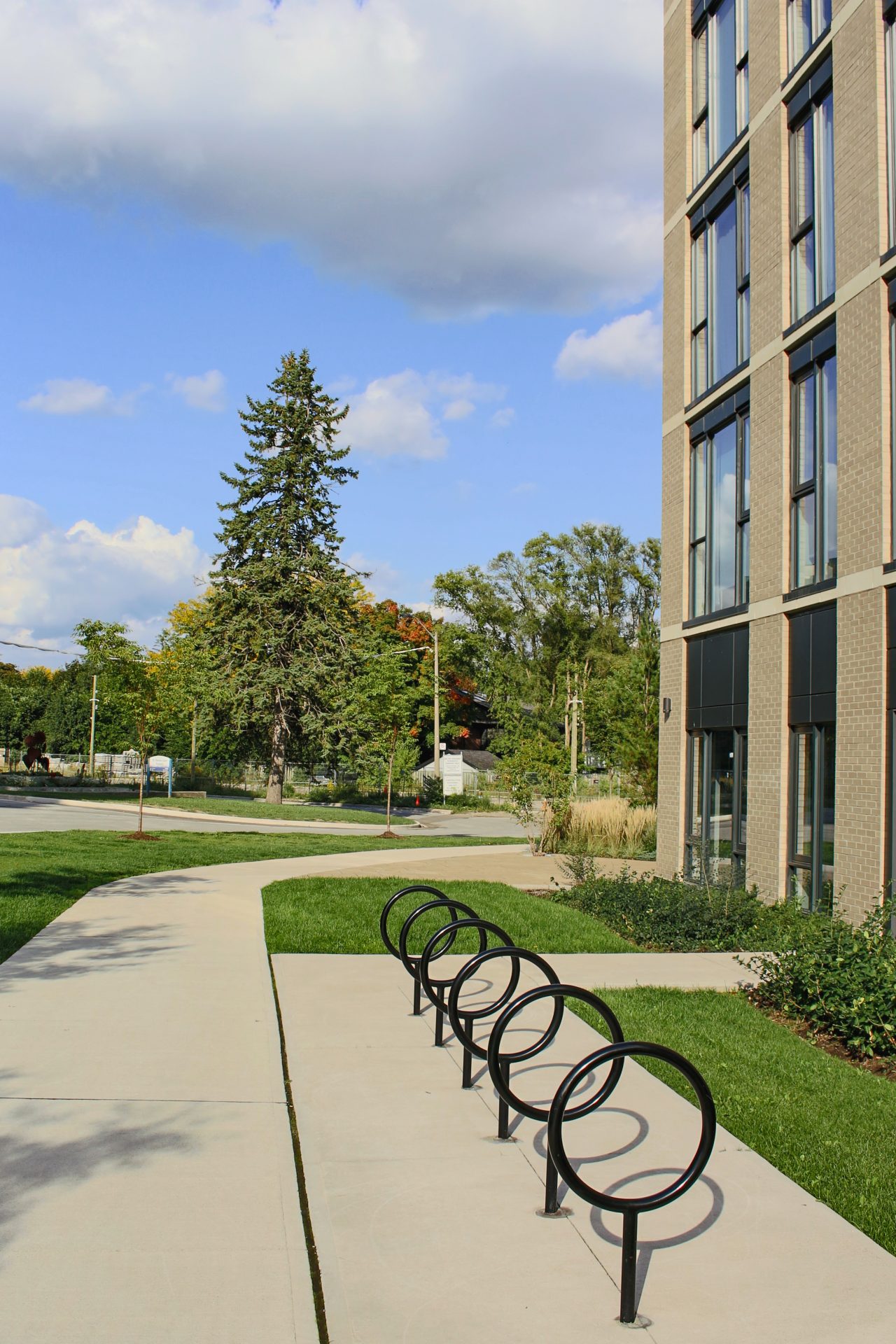 Modern building with bike racks and trees.