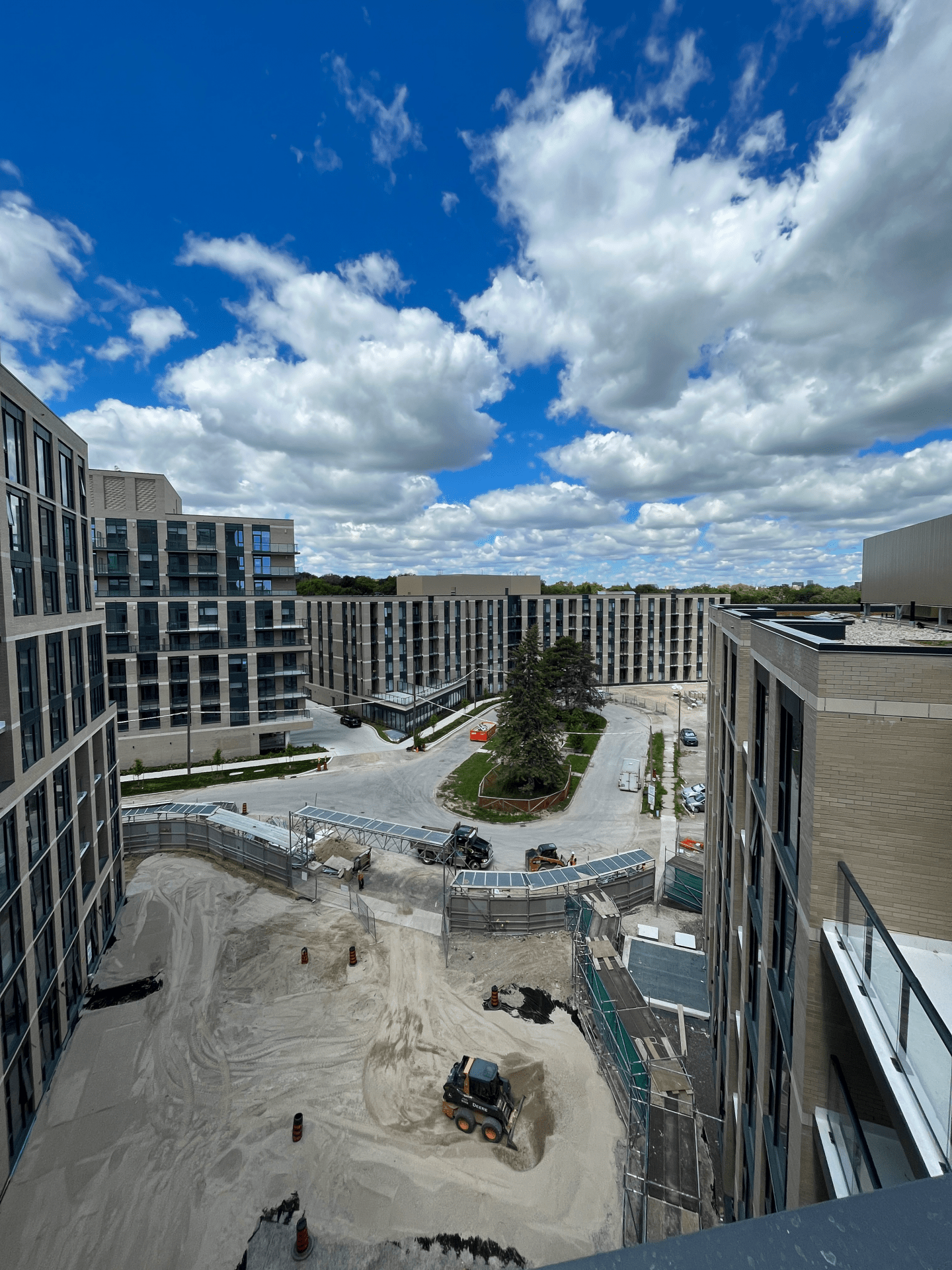 Construction site with buildings under blue sky.
