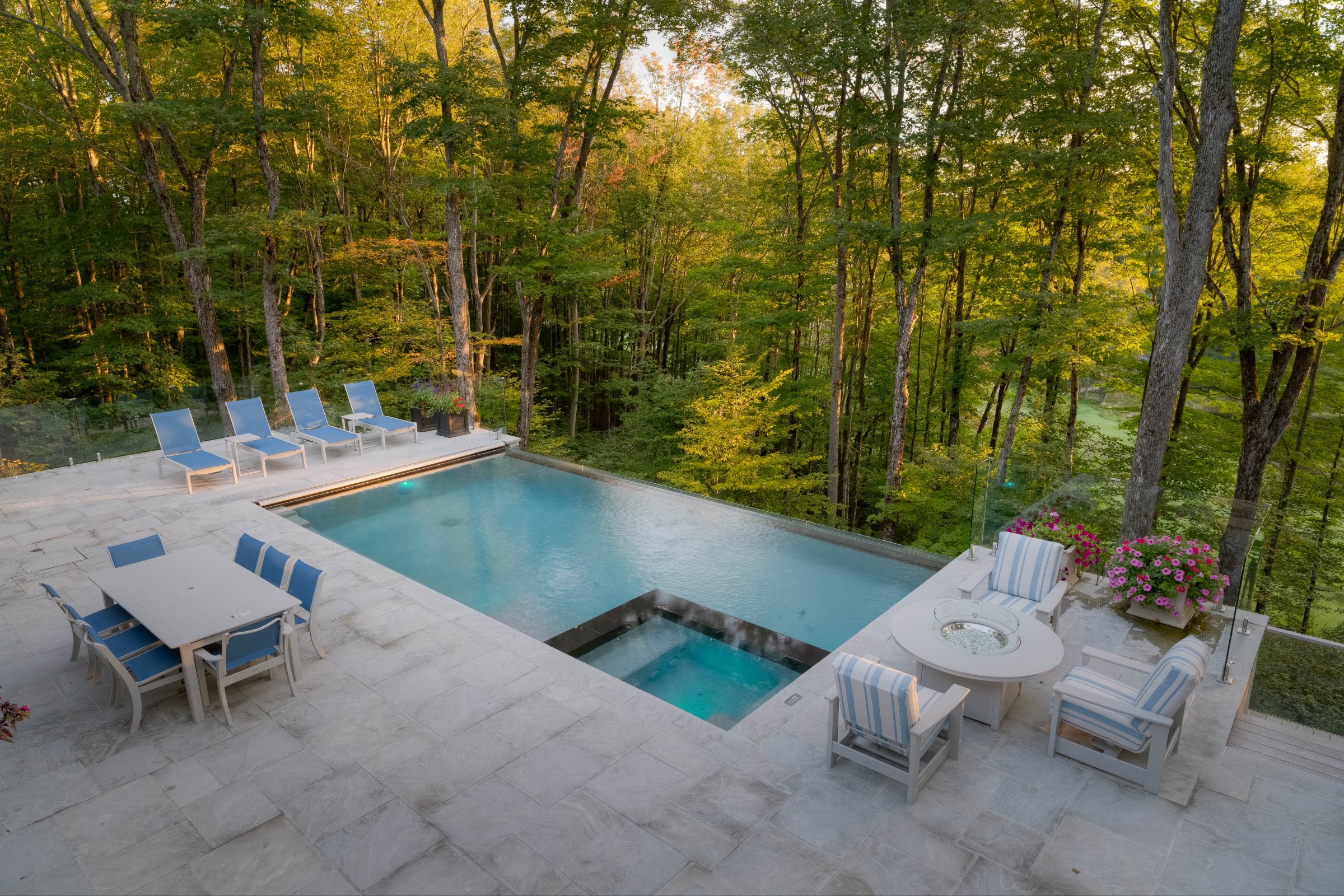 Luxury outdoor pool with forest view.