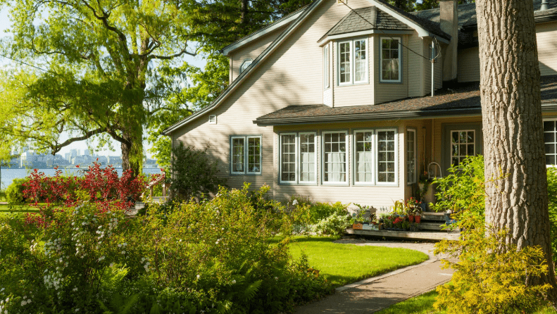 Charming lakeside house with lush garden scenery.