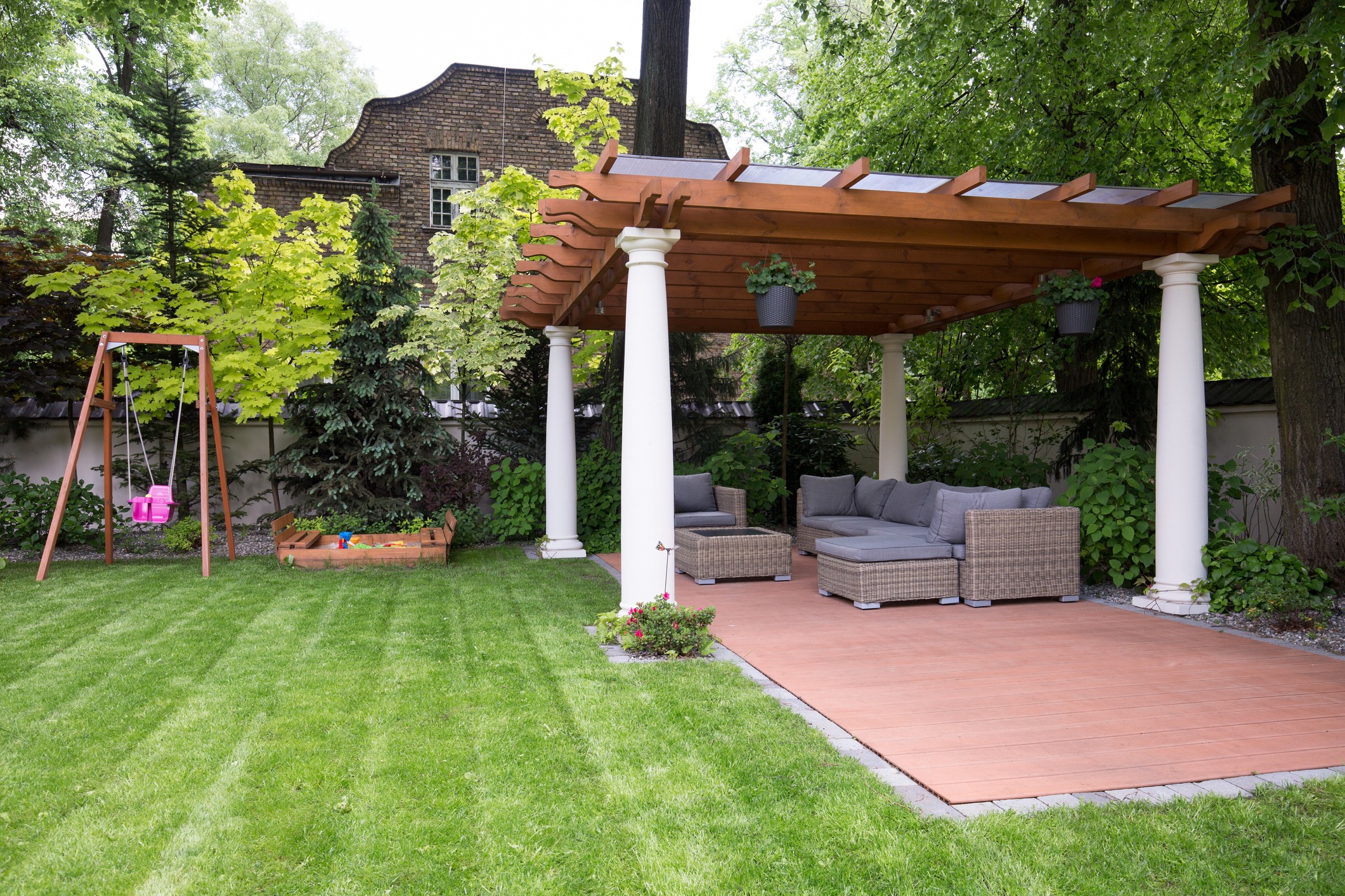 Garden with pergola, swing, and sandbox