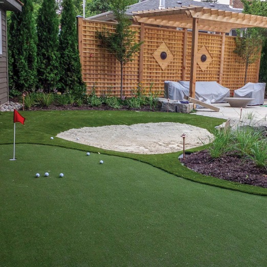 Backyard mini-golf course with sand trap