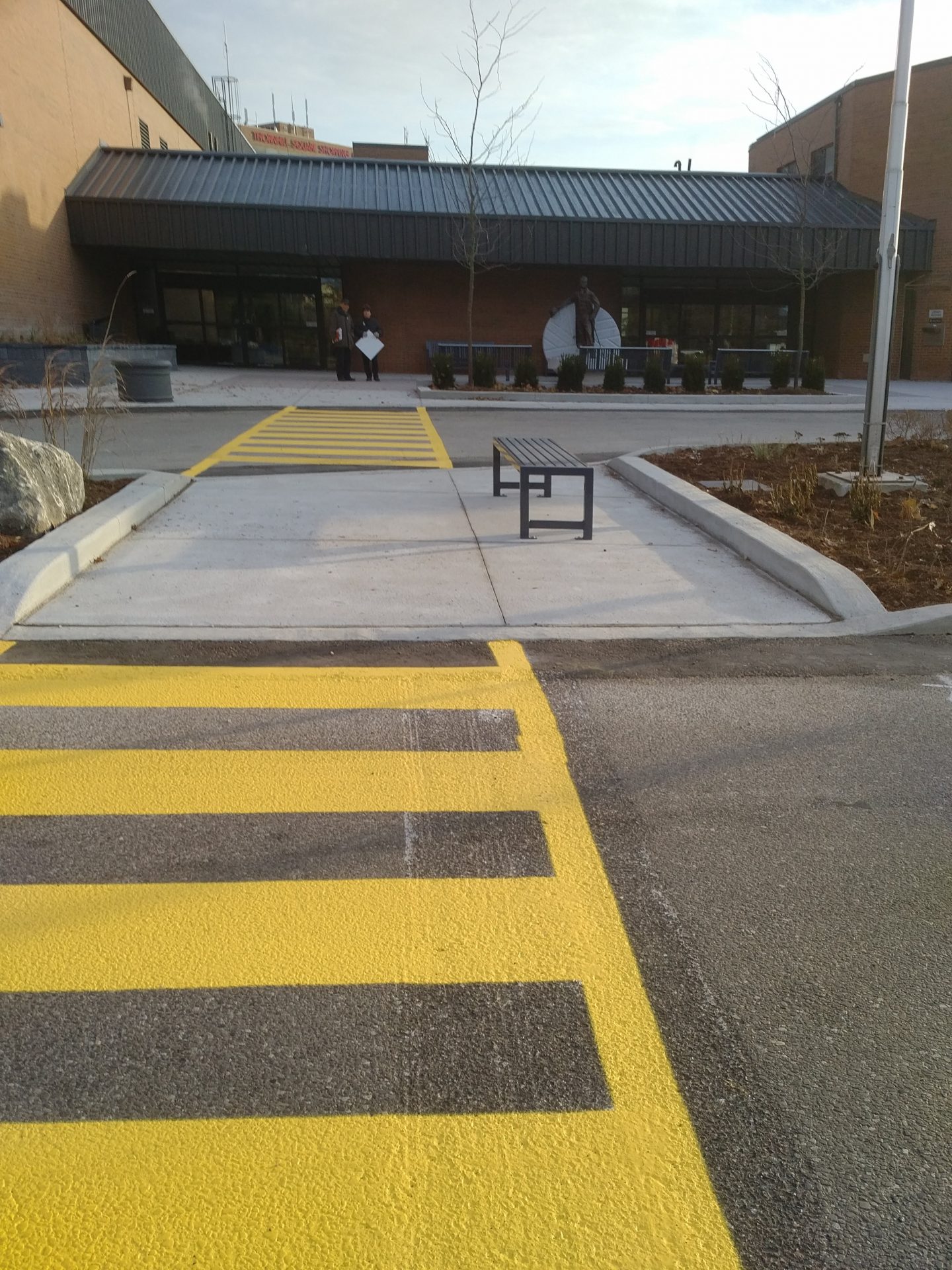 Yellow crosswalk leading to building entrance