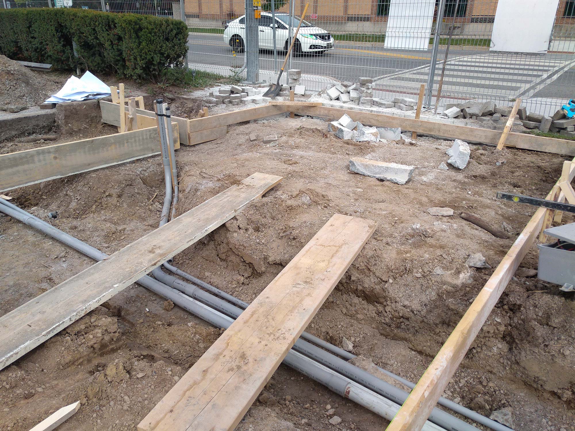Construction site with wooden boards and pipes