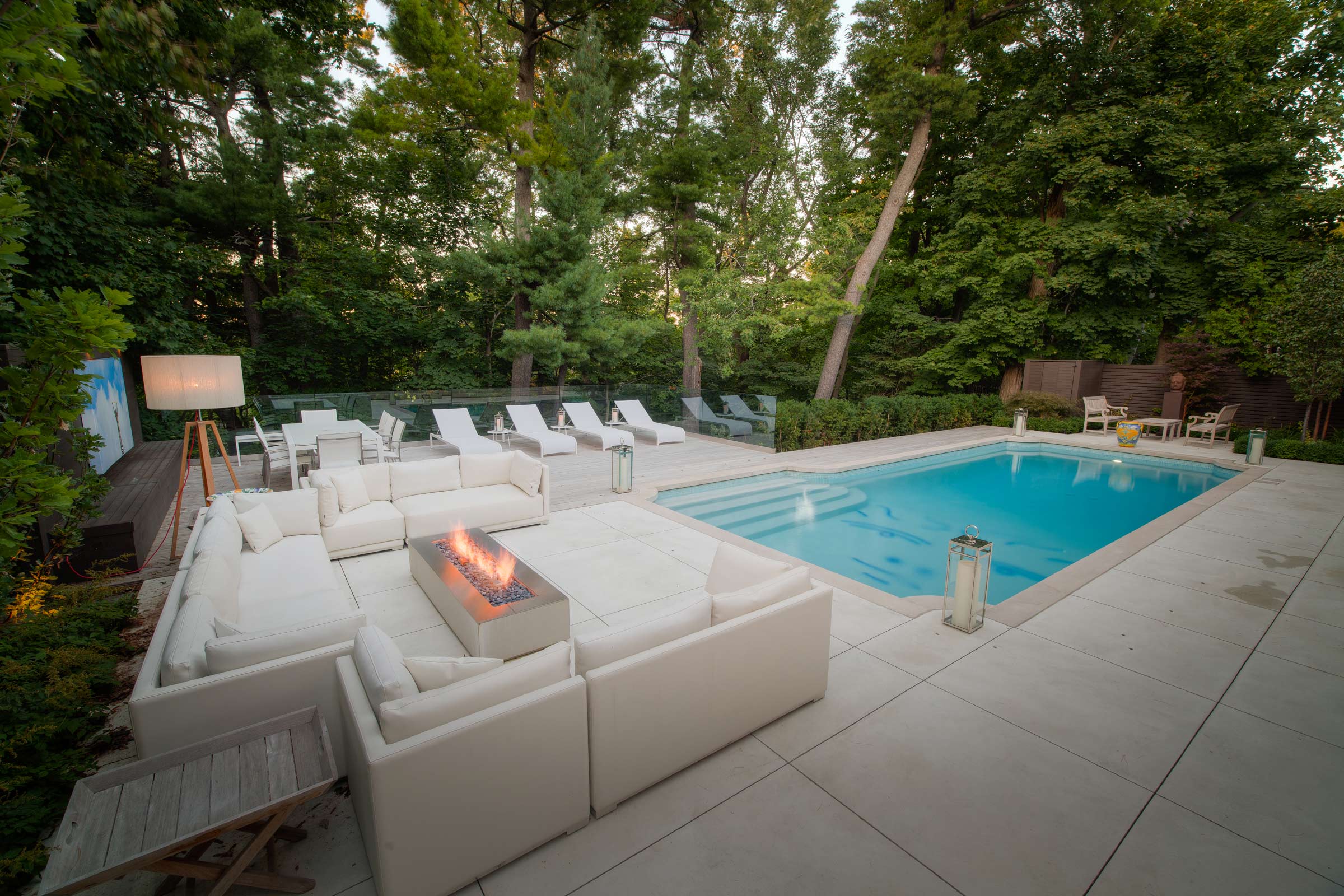 Luxury backyard with pool and modern patio furniture.