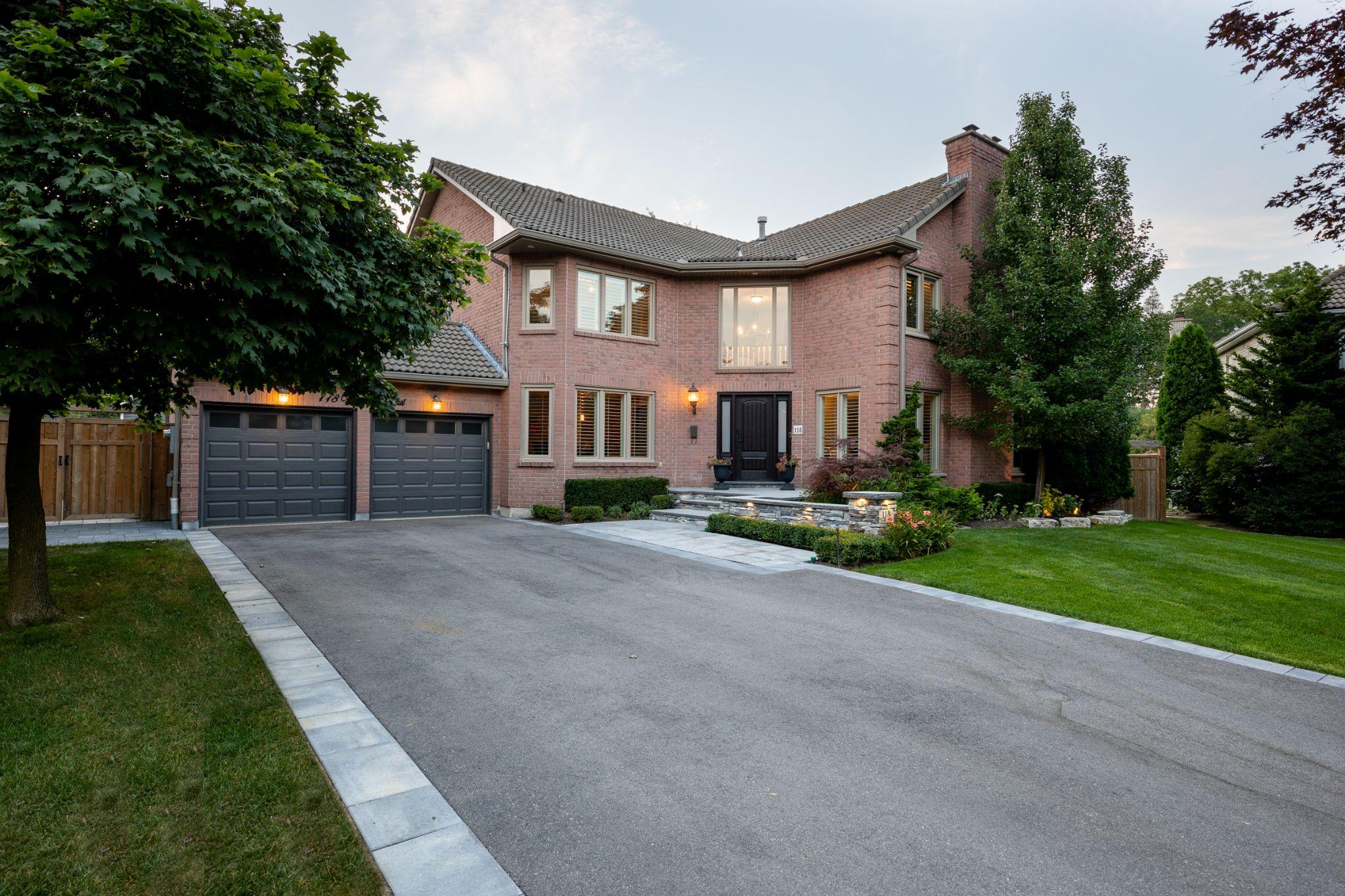 Front yard landscaping with driveway and stone walkway