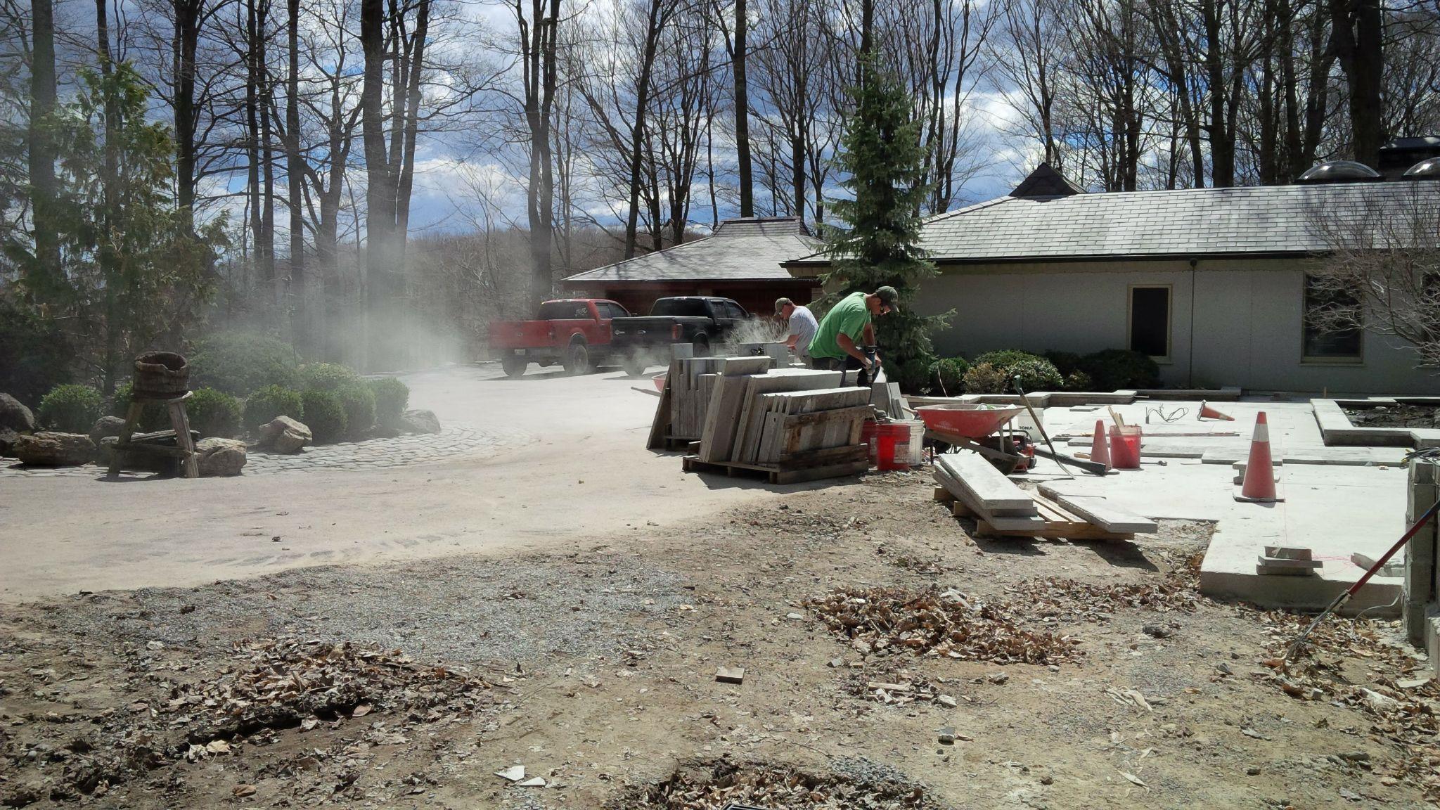 Landscape construction site with patio installation in progress