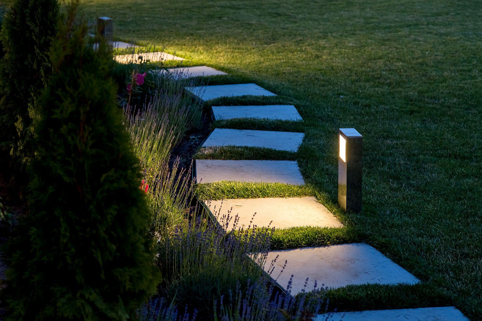 marble path of square tiles illuminated by a lantern glowing