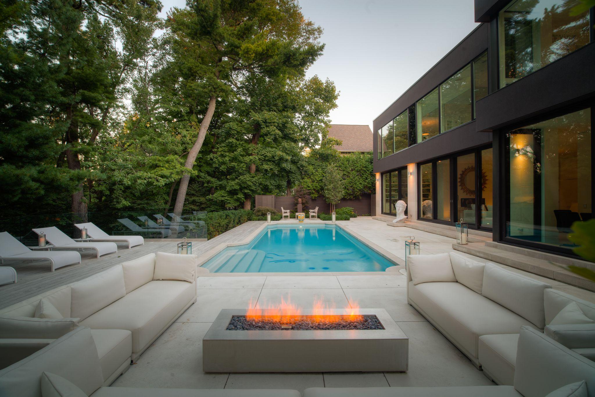 Modern backyard with pool, fire feature, and lounge seating